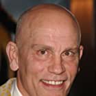 John Malkovich به عنوان Bruce Brazos