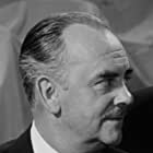 Larry Keating به عنوان Ambassador Alexander Williamson