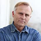 Greg Lutz به عنوان Director Raddock